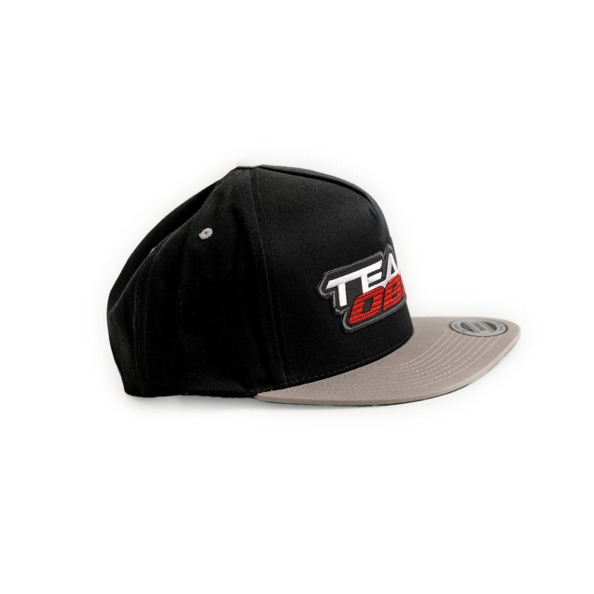 The Classic OG Flat Bill Snapback with black crown, gray bill, and 3D Team OBS logo in red, white, and black