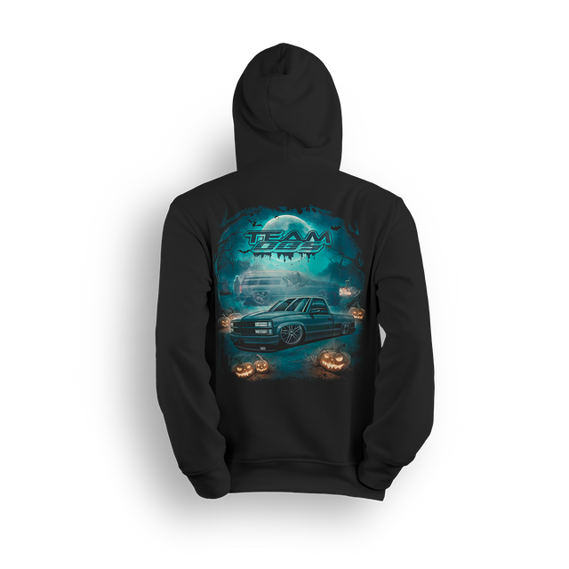 Team OBS Halloween hoodie with slammed single cab and ghost SUV art in a spooky cemetery scene with pumpkins and moonlight
